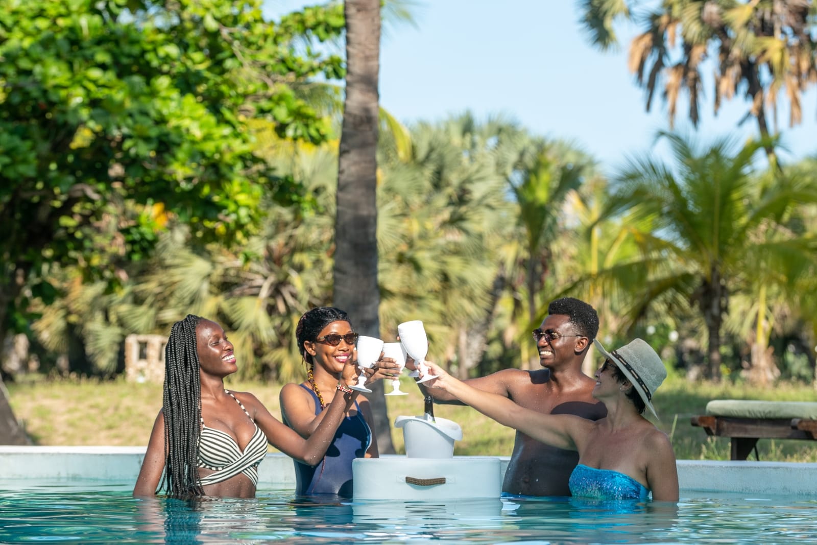 Friends toasting in the pool